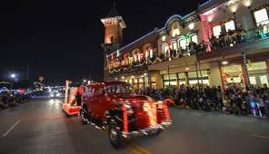 Historic Gruene, Texas lit up with Christmas lights at night — the iconic water tower and storefronts glowing during the holiday season