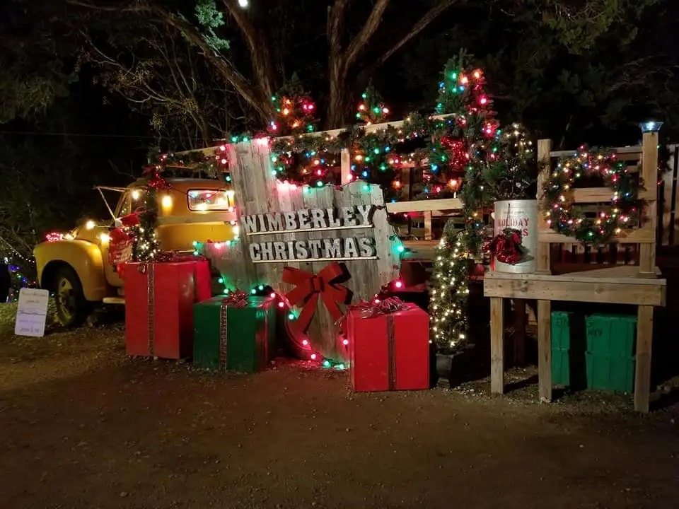 Live oak trees wrapped in thousands of warm white Christmas lights in Johnson City, Texas — the twinkliest town in Texas during the holidays