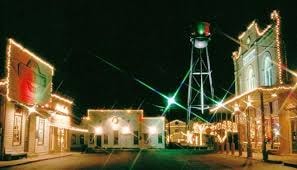 Wimberley Christmas sign surrounded by colorful lights, a vintage truck, and holiday decorations — festive holiday scene in Wimberley, Texas Hill Country