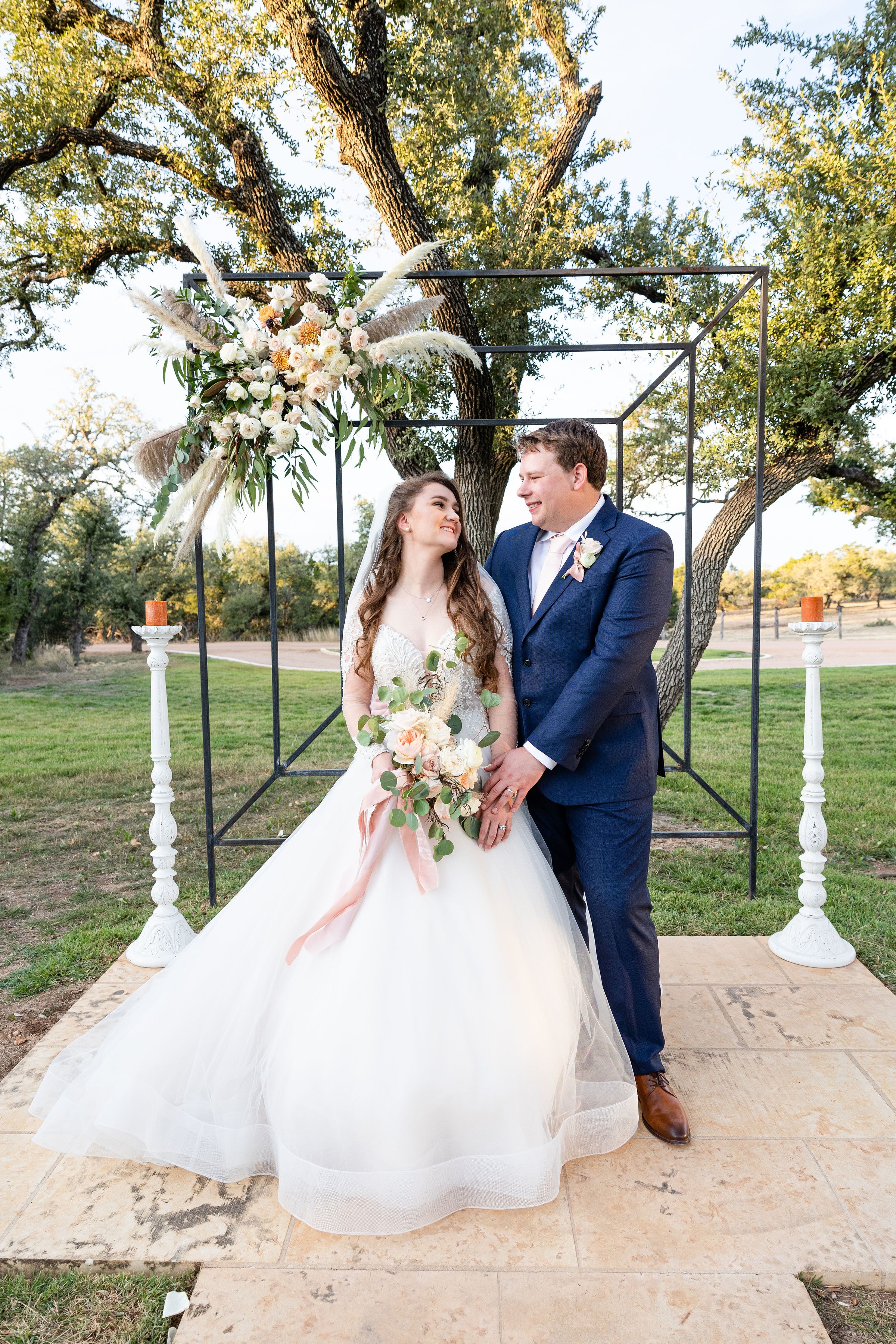 Rylee and John at the altar during their outdoor wedding ceremony at Willow Sky Ranch, Hill Country wedding venue near Fredericksburg TX — near Austin and San Antonio